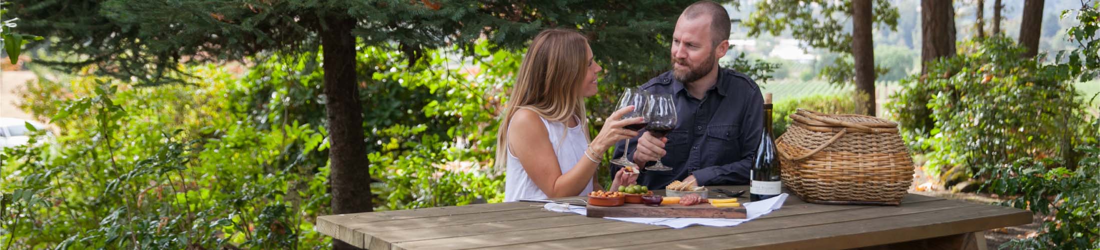 A couple enjoying a picnic with wine in Oregon's Willamette Valley Wine County.